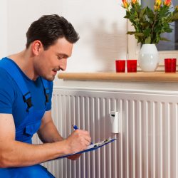 Technician,Reading,The,Heat,Meter,To,Check,Consumption