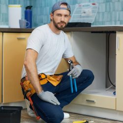 full-length-shot-of-young-handyman-professional-plumber-wearing-tool-belt-looking-at-camera-while-e1705241052245-2.jpg